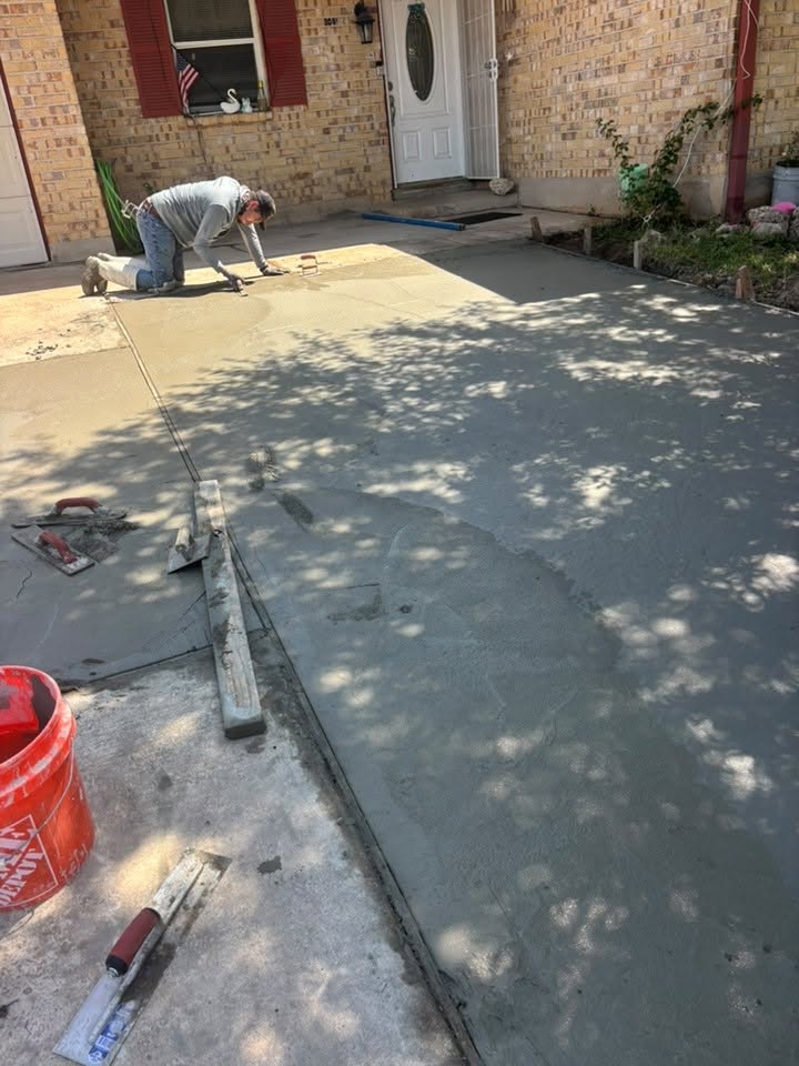 Fresh concrete being finished on the renewed driveway